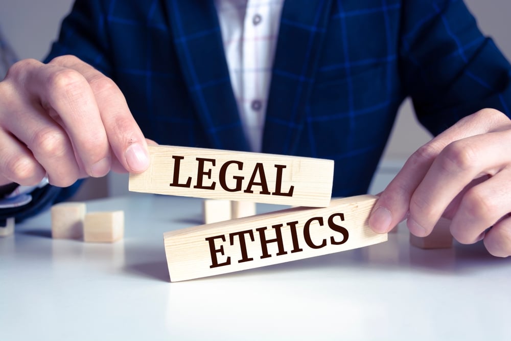 Closeup,On,Businessman,Holding,A,Wooden,Block,With,"legal,Ethics",