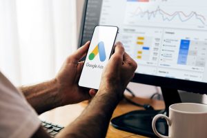 Man,Using,A,Mobile,Phone,With,Google,Ads,On,The