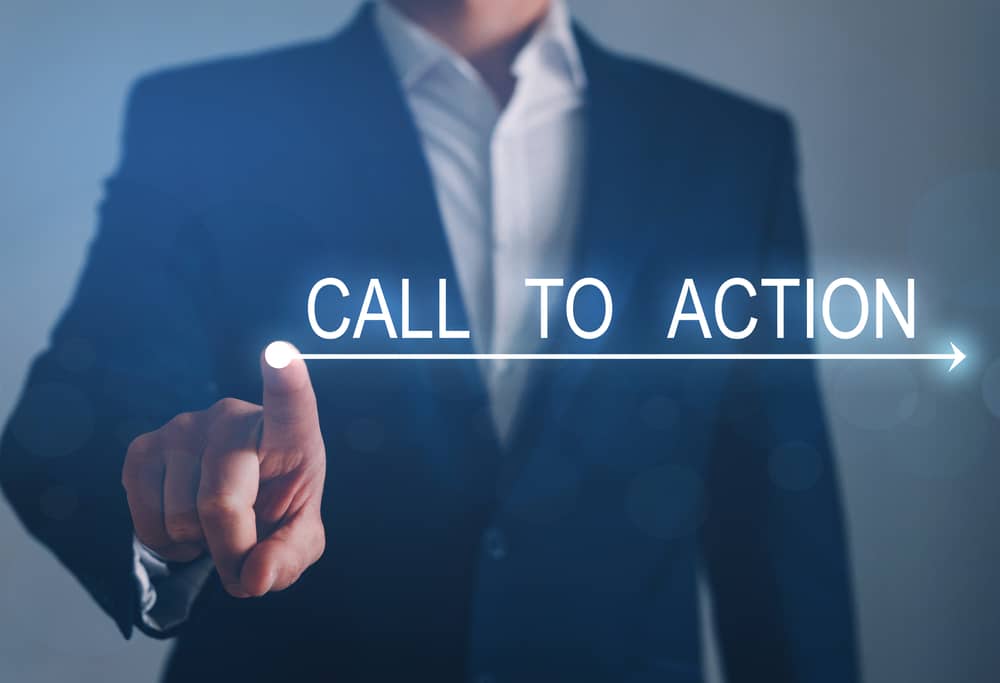 BusinessmanWritingCallToActionBusinessConcept Businessperson in a suit points toward a glowing